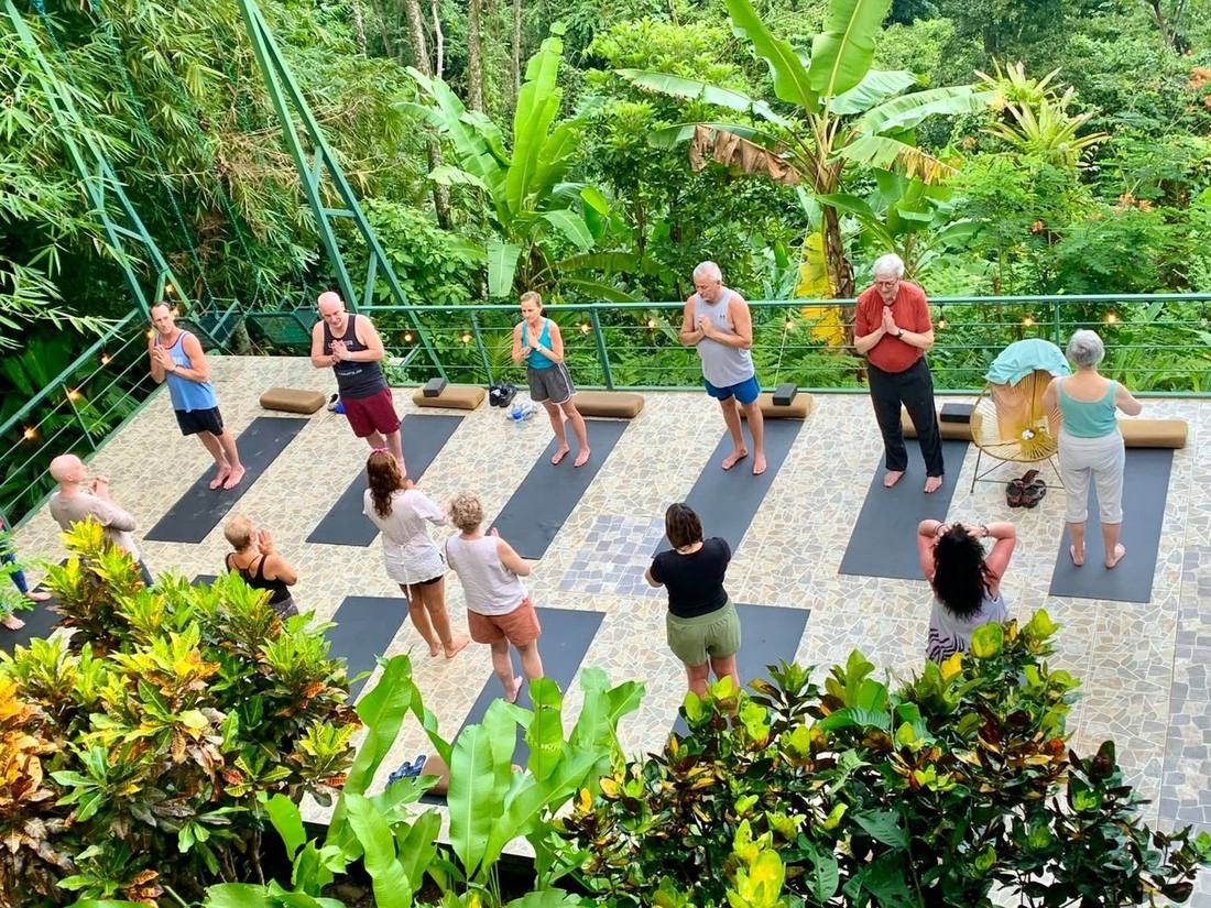 Jazmin guiding a group class on an open-air deck in the jungle